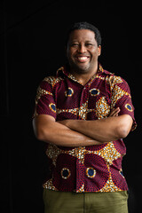 Portrait of handsome black man smiling with arms crossed