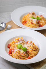 spaghetti with tomatoes, basil and parmesan cheese