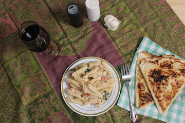 Plate of Pasta Carbonara With Italian Flat Bread on Rustic Table