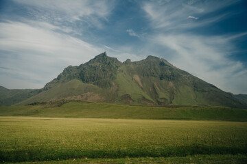 Scenic view of green landscape against sky at Iceland