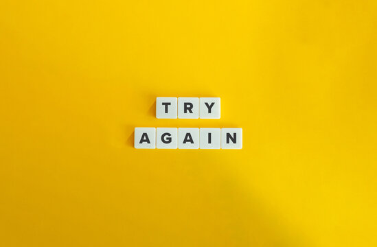 Try Again Phrase. Concept of Resilience, Encouragement, Persistence, Determination, Perseverance, and Continued Effort. Text on Block Letter Tiles on Yellow Background.