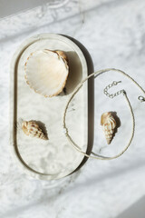 decorative stand with necklace and shells