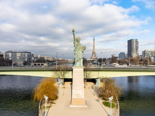 Aerial drone view of the the Statue of Liberty of Paris, France, with The Eiffel Tower in the...