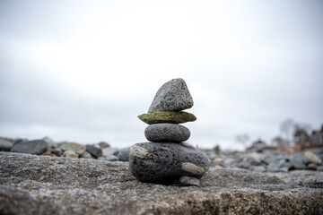 Stacked cairn stone zen sculpture on New England beach