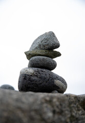 Fototapeta na wymiar Stacked cairn stone zen sculpture on New England beach