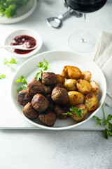 Homemade veal meatballs with potato and berry sauce