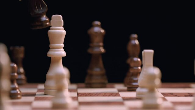 Caucasian Woman's Hand Plays Knight Takes King, Checkmate - Close-up Macro. Shot with ARRI Alexa in ArriRaw at 120 fps, exported 23.98 fps QuickTime Apple ProRes 422 HQ.