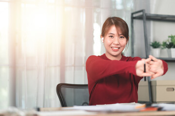 Businesswoman relaxing ,tense muscles ,Take a break from work at the laptop ,stretching muscles ,Stretching Her Arms ,Resting and stretching after work ,exercise at work ,Fatigue relief ,health care