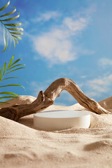 A white podium in round-shaped displayed on the sand with a big tree branch and some green tropical...
