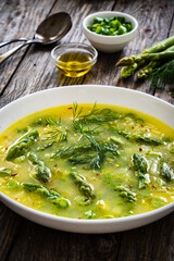 Asparagus soup on wooden table

