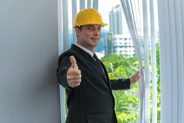 Young Caucasian engineer man open window shade and making thumbs up, Engineer Business Office