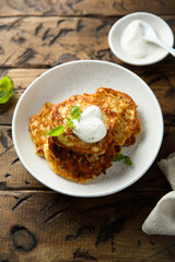 Traditional homemade latkes with sour cream