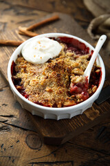 Traditional homemade berry crumble with cream