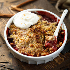 Traditional homemade berry crumble with cream