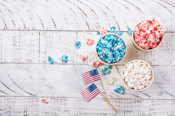 Golden paper cups with red, blue, white popcorn. US colors for 4th july. Snack food for USA independence day celebration