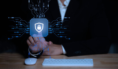 Businessman touch virtual screen on computer,Cyber secutiry concept,A shield protects the laptop from virus from the internet.	
