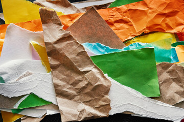 Abstract photo composition made from colorful pieces of torn crumpled paper. Different textures display of diversity. Reuse paper trash to create a new collage