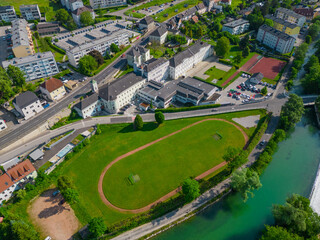 school with a football field alongside a river