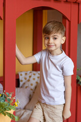 the boy smiles near the crib
