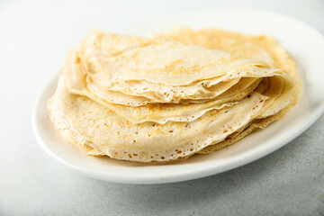 Traditional homemade crepes on a white plate