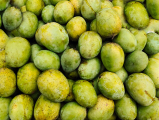 close up of green yellow mangoes, Organic Ripe Mango sale in market close up photo, delicious healthy sweet and green mango