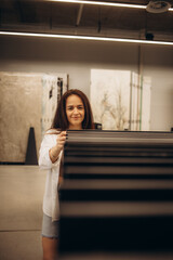 Portrait of a cheerful latin woman looking to buy new tiles for her kitchen at the floor shop.