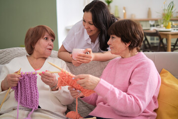 trio of radiant females, each representing different generation, engage in vibrant conversations and exchange heartwarming moments in cozy domestic ambiance. cross-generational dialogue