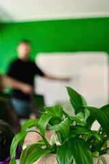 people at a meeting talking in the office with a plant in front