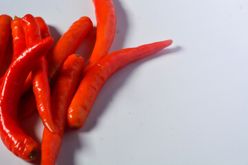 Scene of the red chili which looks very hot against a white background. No people.