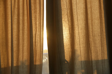 Sunlight breaking through curtains, summertime, golden hour time