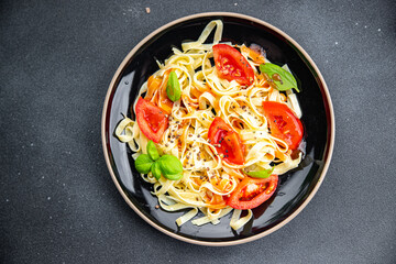 tagliatelle pasta fresh tomato  meal food snack on the table copy space food background rustic top view veggie vegan or vegetarian food
