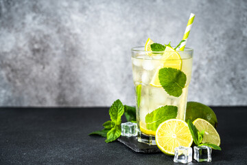 Mojito with rum and lime on black background. Tradition Summer drink with ice.