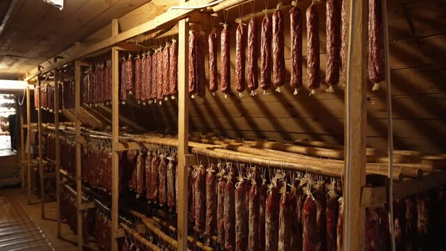 Seasoned cured sausage hangs in the dryer