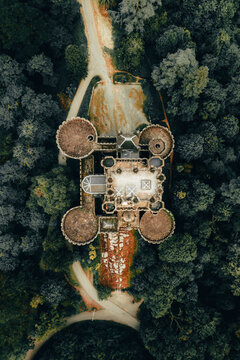 An enchanting aerial view of Butron Castle, nestled amidst lush greenery, exuding a sense of history and grandeur.