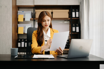 Confident business expert attractive smiling young woman holding digital tablet  on desk in creative office.