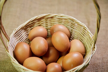 Close-up of raw eggs in wicker basket