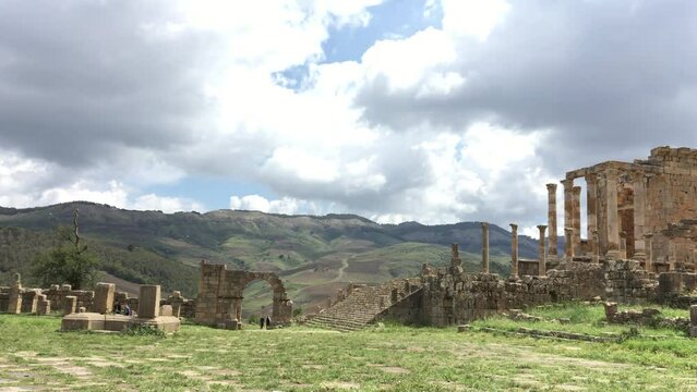 Algerian tourists walk in the ancient Roman town of Cuicul on a cloudy day. Djemila, Setif, Algeria