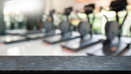 Empty black marble stone table top on blurred with bokeh Exercise room, fitness and gym interior...