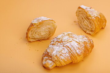 Good morning concept. Fresh croissants with cream filling and almond flakes. Sweet dessert