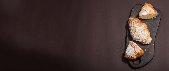 Good morning concept. Fresh croissants with cream filling and almond flakes. Sweet dessert