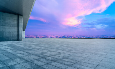 Empty square floors and city skyline with colorful sky clouds at sunset