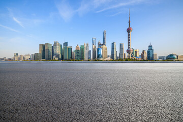Asphalt road and city skyline with modern buildings in Shanghai, China.