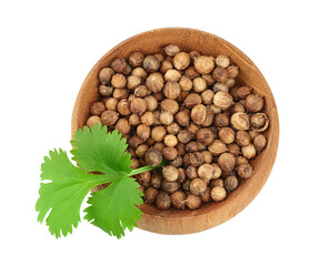 Dried coriander seeds in the wooden bowl with fresh green leaf isolated on white background. Top view. Flat lay