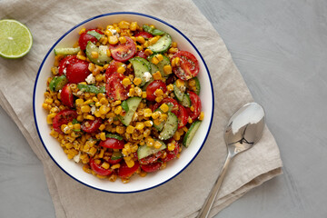Summer Homemade Corn Salad with Cucumber and Feta, top view. Overhead, from above, flat lay.