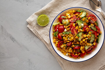 Summer Homemade Corn Salad with Cucumber and Feta, top view. Overhead, from above, flat lay.