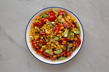 Summer Homemade Corn Salad with Cucumber and Feta, top view. Overhead, from above, flat lay.