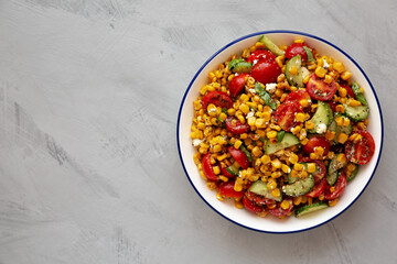 Summer Homemade Corn Salad with Cucumber and Feta, top view. Overhead, from above, flat lay. Space for text.
