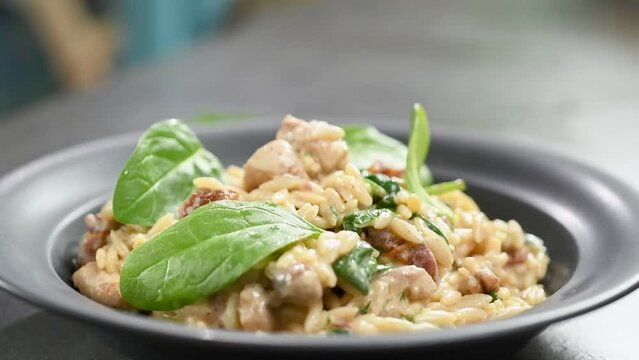 Eating freshly cooked chicken with orzo pasta.
