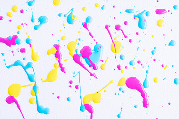 The puddles of an bright yellow oil paint spill. Watercolor yellow drop splash. Splatter of ink drops on white paper background. Sample of cosmetics.
