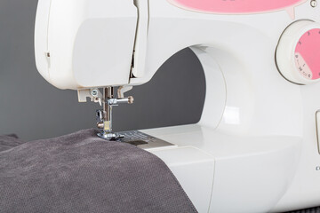 Sewing machine, stitching fabrics, needle in a round plan